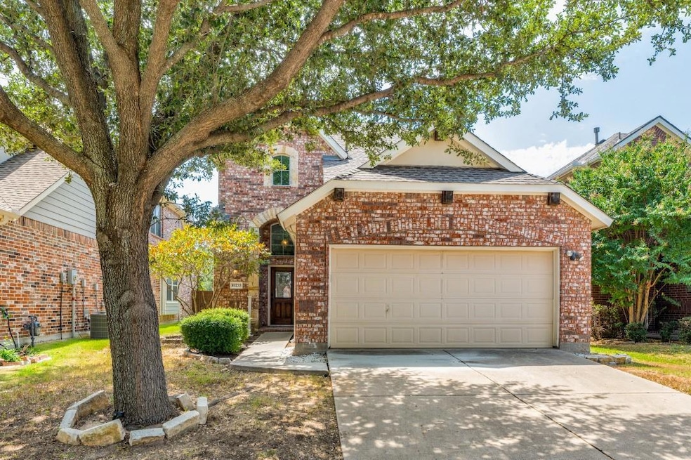 View of front of home featuring a garage and centr