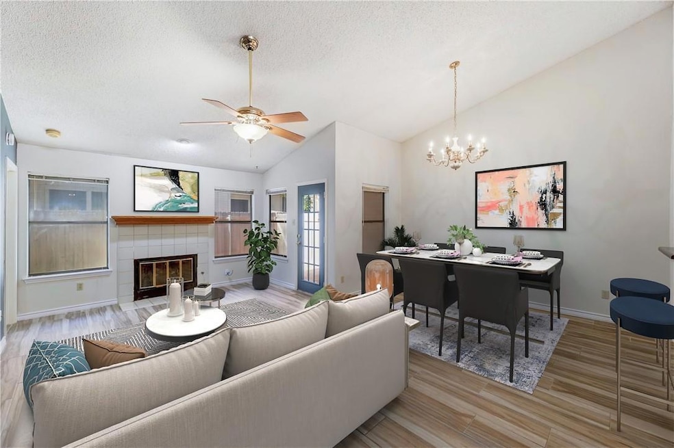Living room featuring wood finished floors, vault