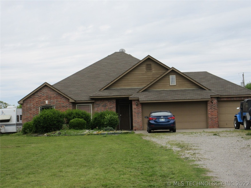 Brick home on about 1.5 acres with 3 car garage.