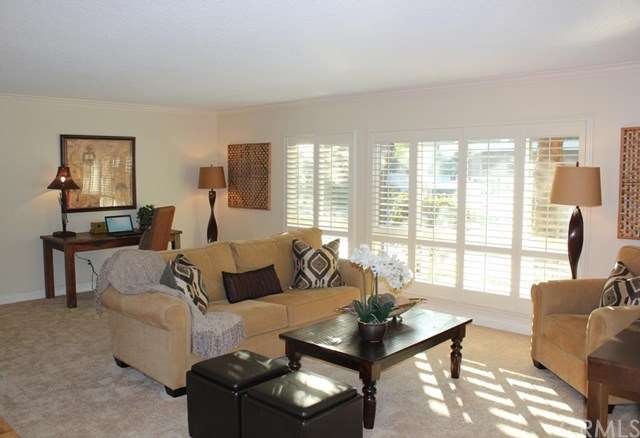 Spacious living room features plantation style shu