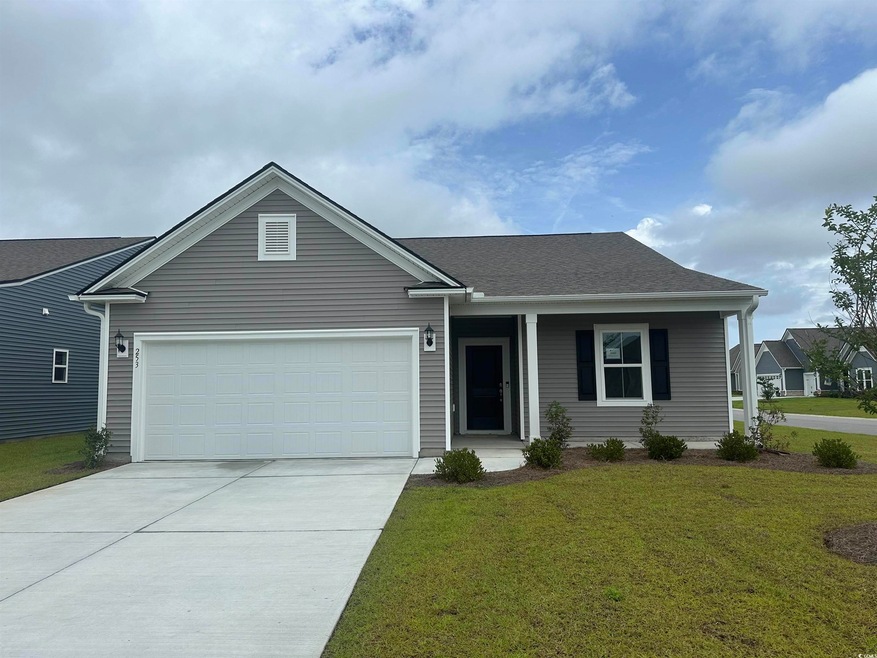 Ranch-style home with a garage, driveway, a front lawn, a porch, and roof with shingles