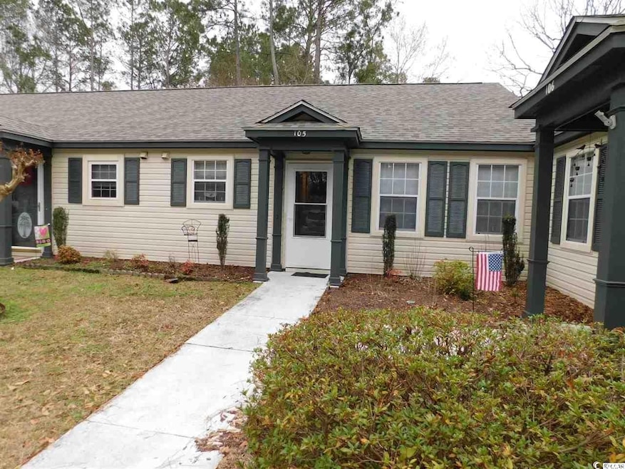 View of front of house featuring a shingled roof and a front yard