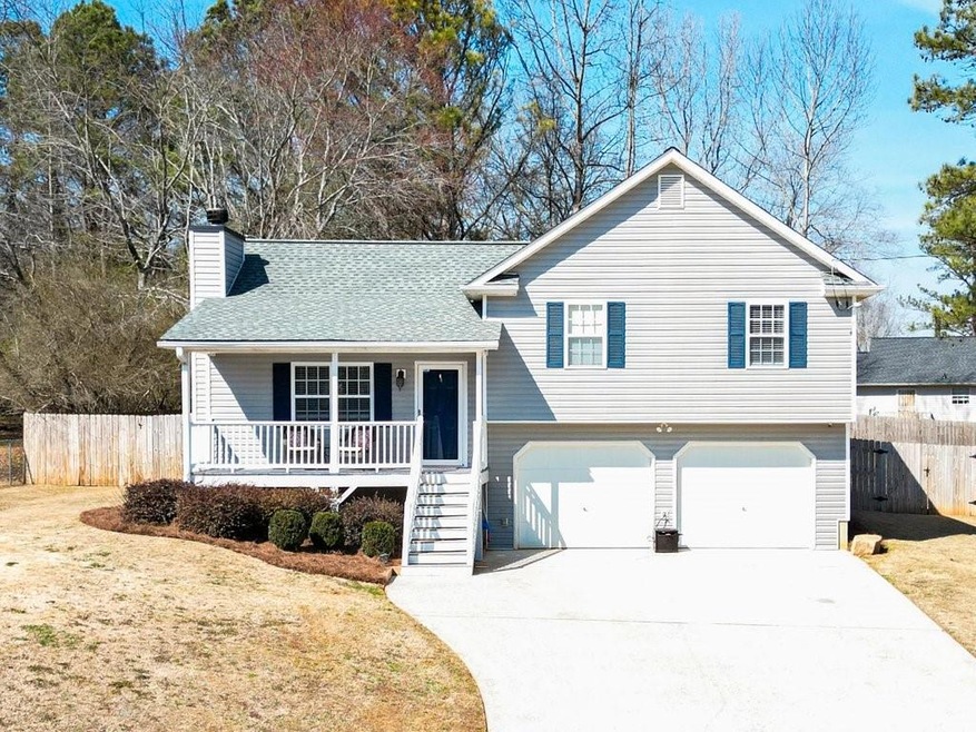 Split level home featuring a garage and a porch