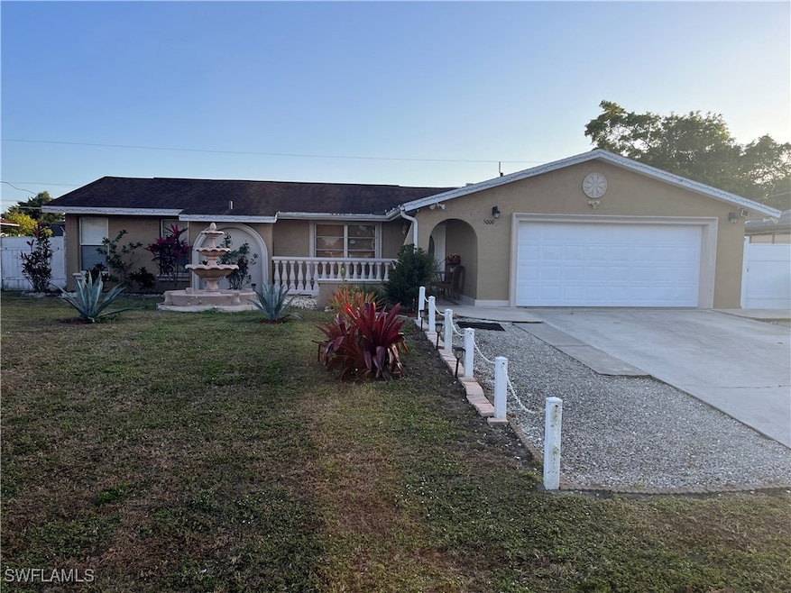 Ranch-style house with a garage and a front yard