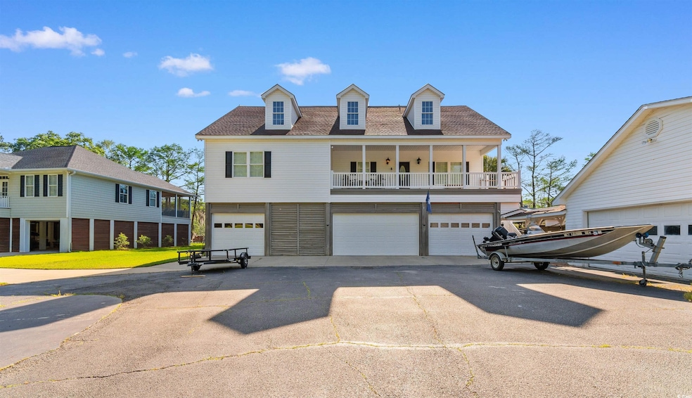 View of front facade featuring a front lawn, a shi