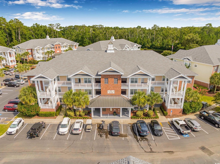 View of property with uncovered parking