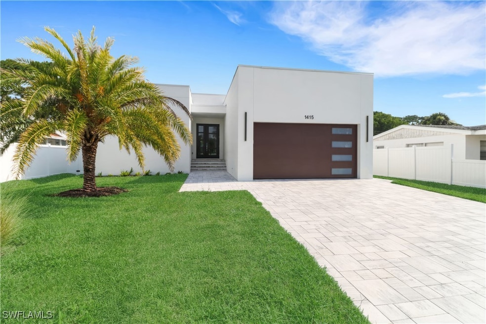 Modern home with decorative driveway, stucco sidin