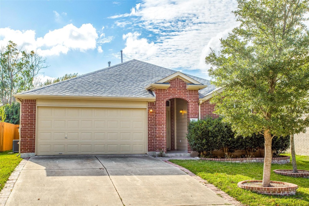 Traditional home featuring concrete driveway, roo