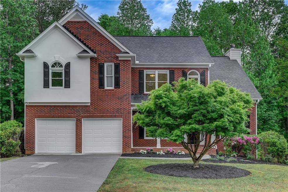 View of front facade featuring brick siding, an at