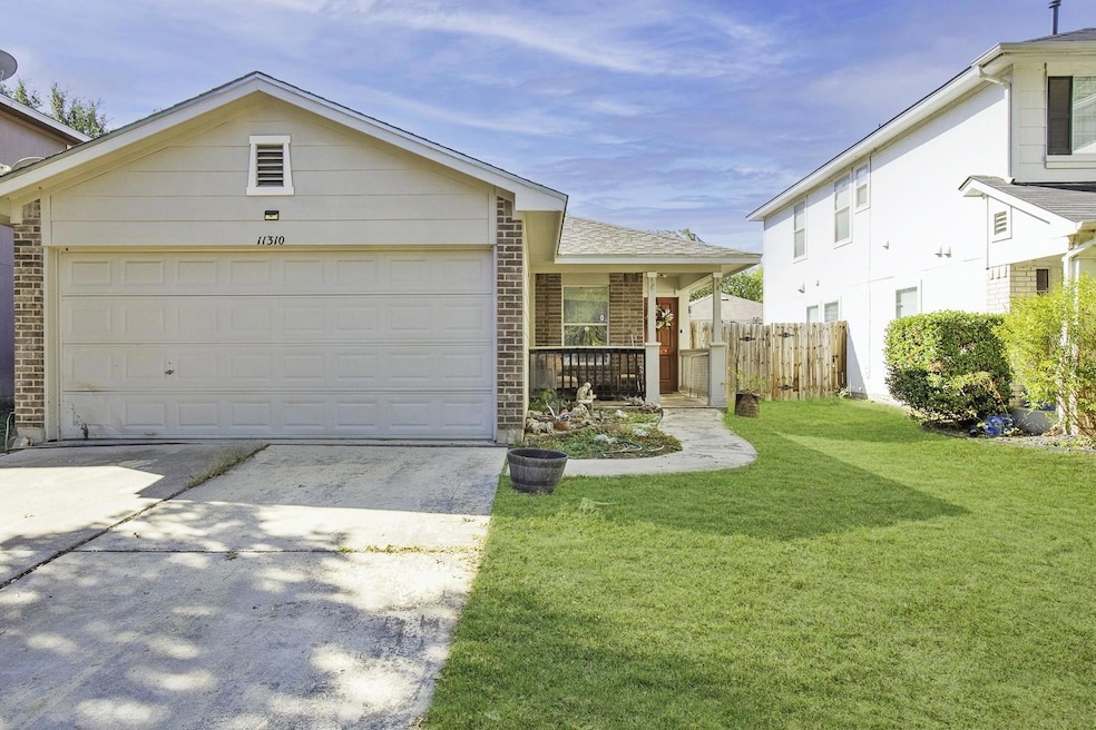 View of front of house with brick siding, drivewa