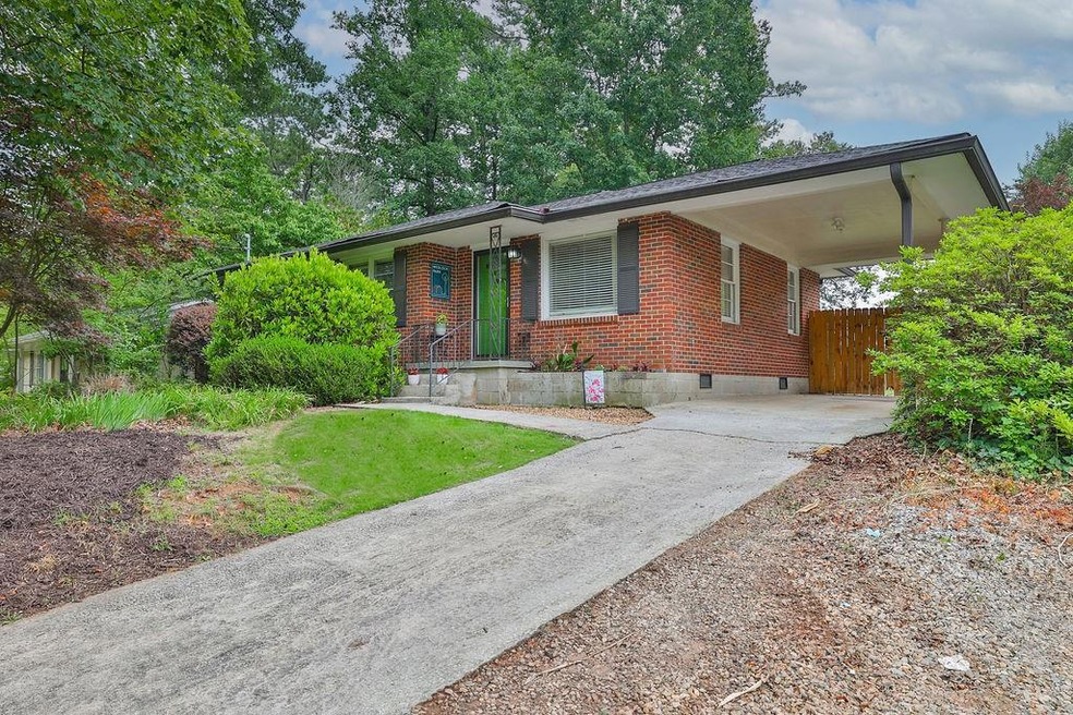 Ranch-style house featuring a carport