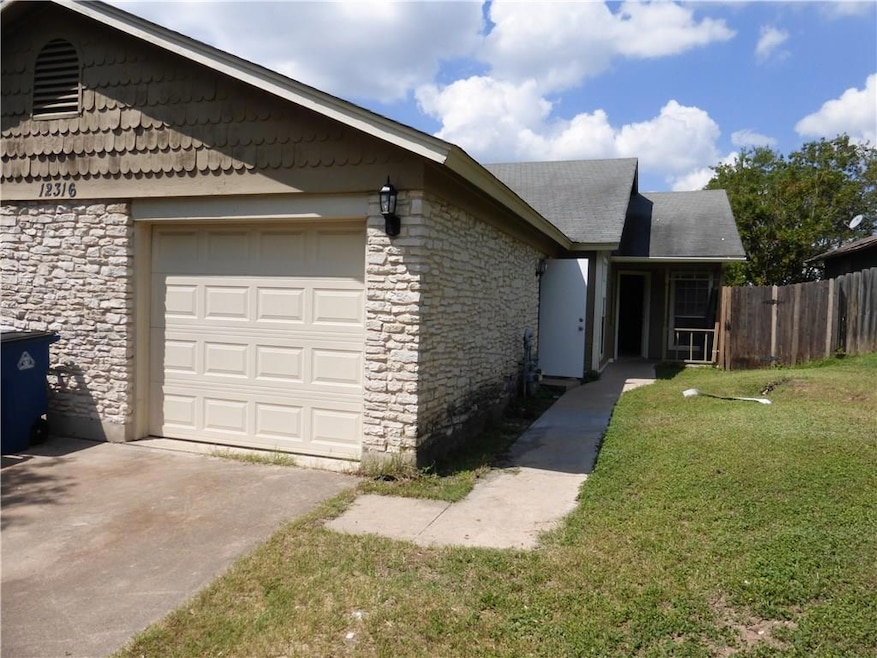 View of side of home featuring stone siding, an a