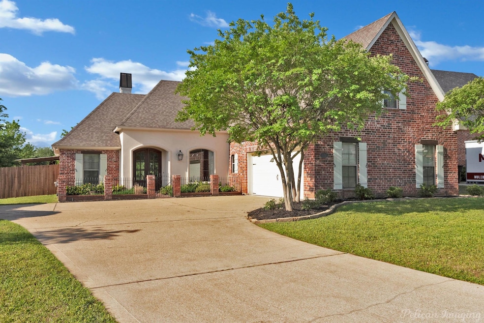 View of front of home with a chimney, fence, concr