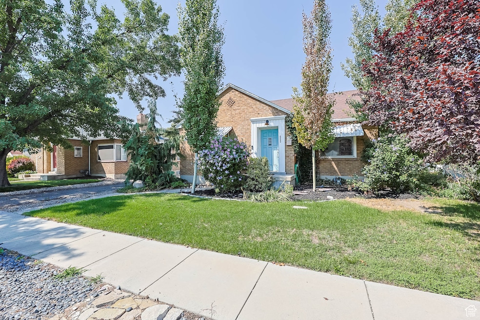 View of front of home featuring brick siding and a front lawn