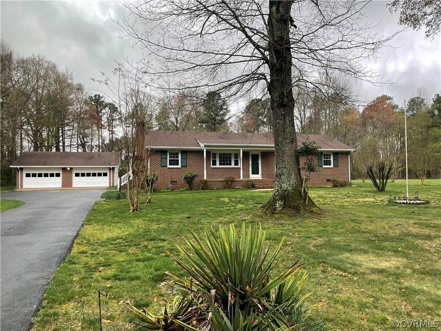 Single story home featuring a front yard and a garage