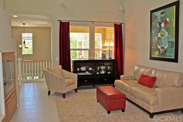 Large living room has soaring ceilings and contemp
