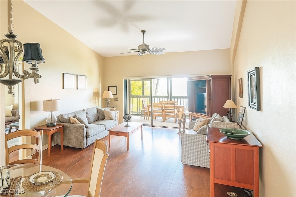 Living room featuring wood finished floors and vaulted ceiling