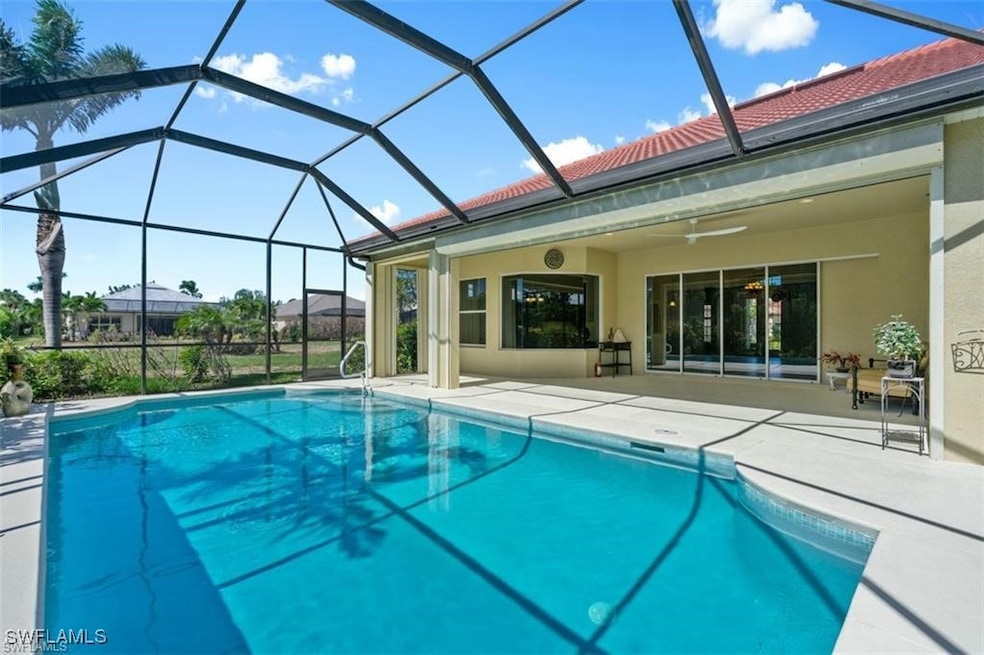 Pool with a lanai, ceiling fan, and a patio area