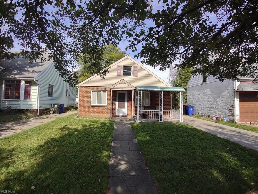 Bungalow-style house with a front lawn, a garage, and a porch