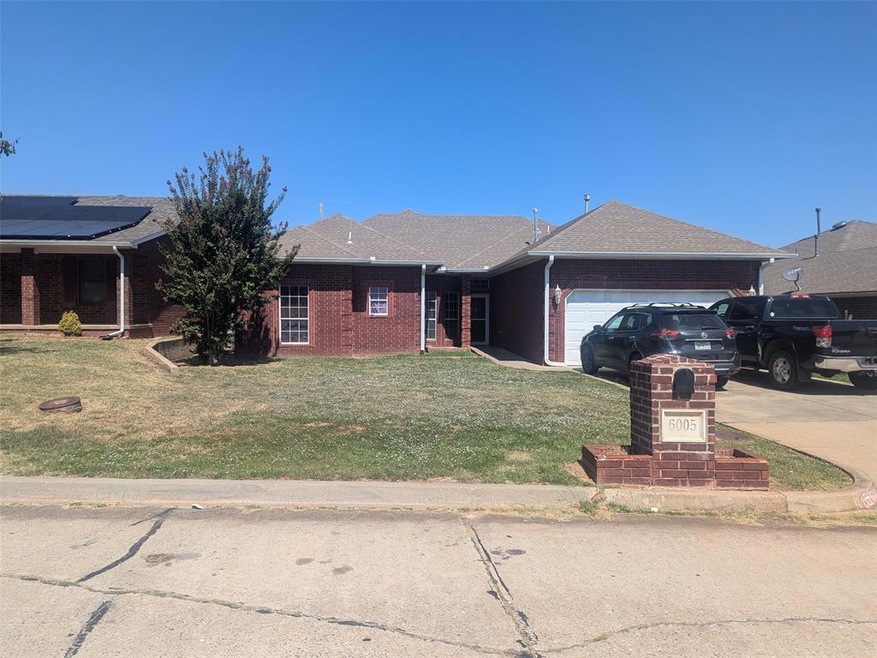 Ranch-style house featuring a front yard and a gar