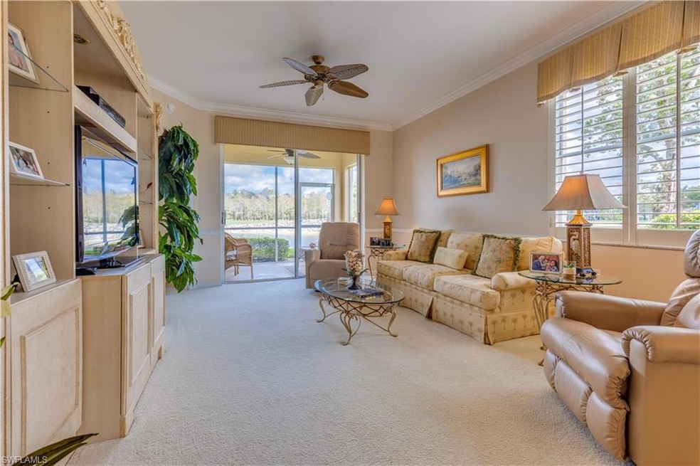 Living room with crown molding, plenty of natural 