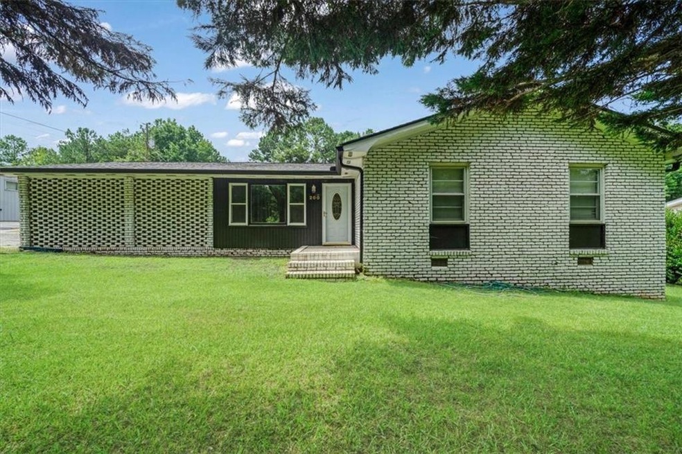 View of front of home featuring a front yard and brick siding
