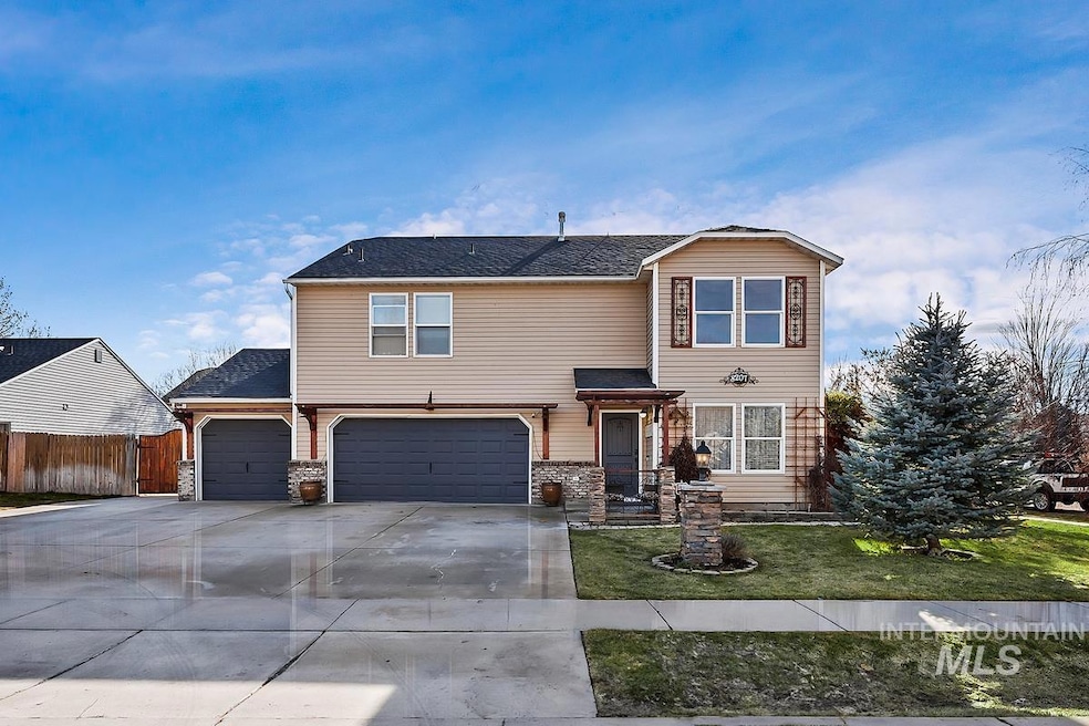 View of front of house featuring concrete driveway, an attached garage, and a shingled roof
