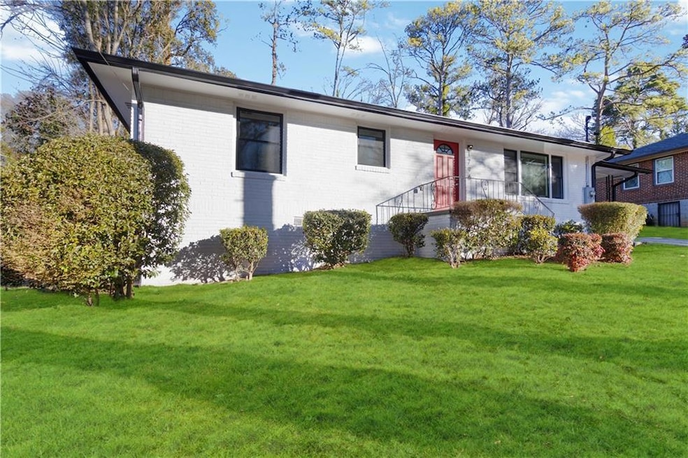 View of front of house featuring brick siding and a front yard