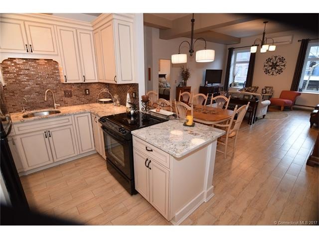 Glass tiled backsplash with under counter lighting