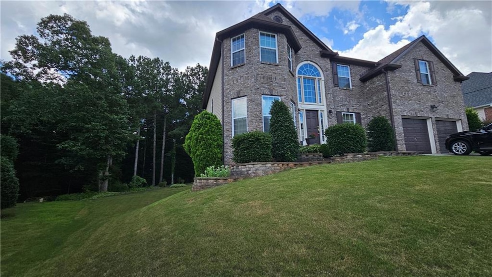 Traditional-style home with a garage and a front lawn