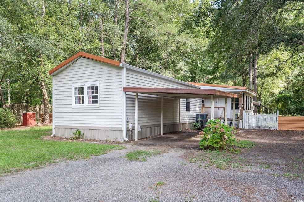 View of side of property featuring a carport and c