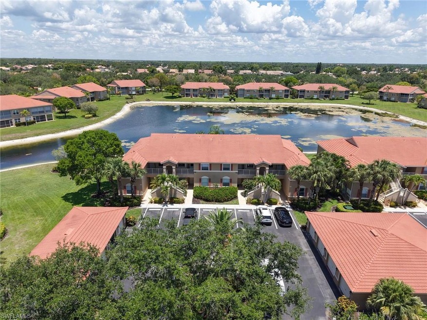Aerial perspective of suburban area featuring a nearby body of water
