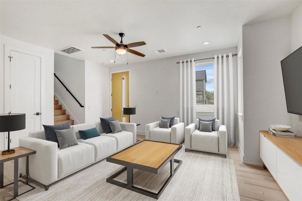 Living room with ceiling fan, light wood finished