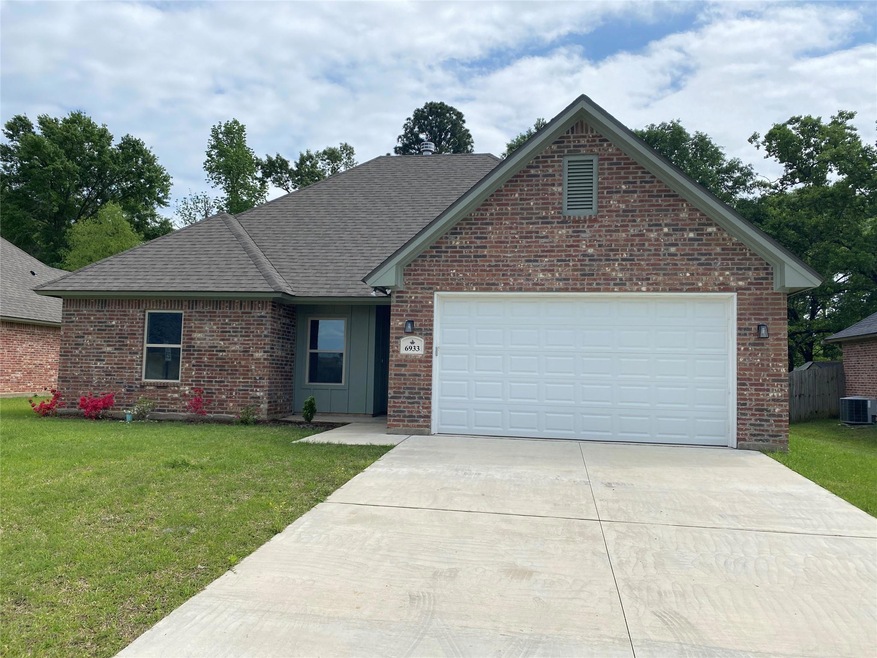 View of front of home with a garage, central AC, a