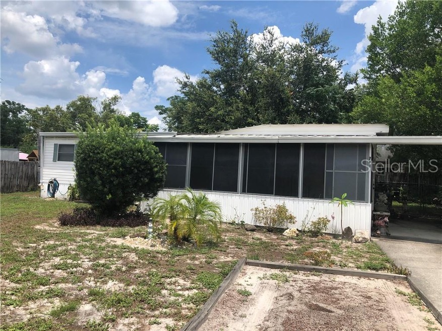 Front of home with carport and guest parking