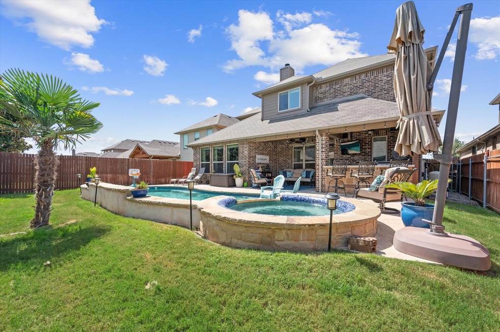 View of swimming pool featuring an in ground hot t