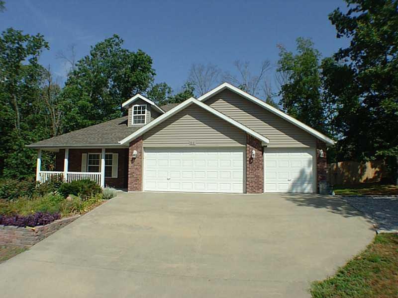Exterior Front. 3 Car Garage, w/ extra parking area. Home On Sewer