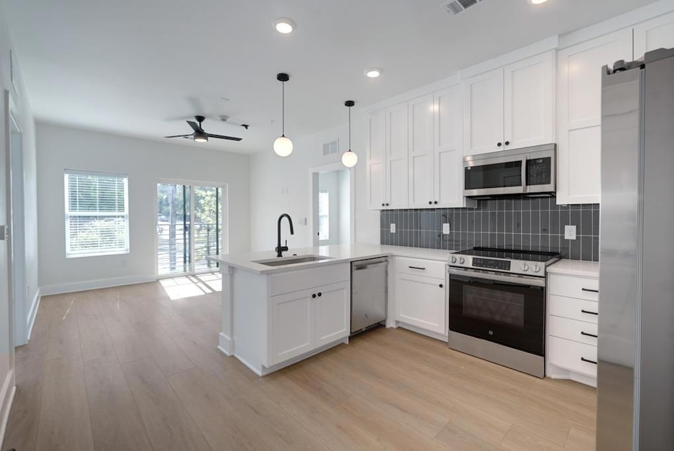 Kitchen with stainless steel appliances, a sink, 