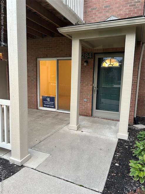 Doorway to property featuring brick siding