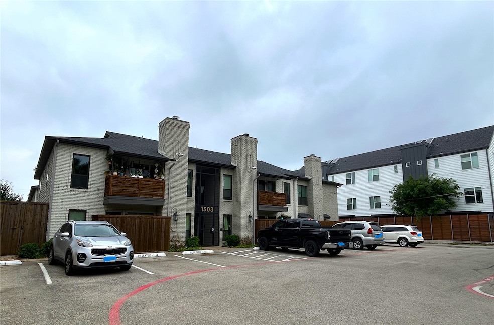 View of building exterior with uncovered parking