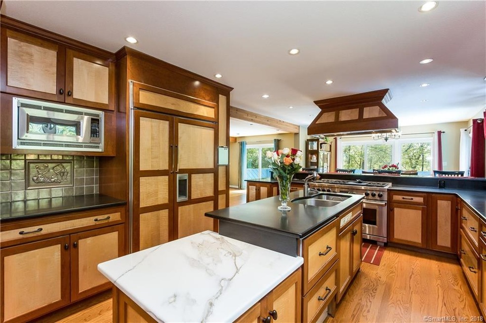 Custom kitchen with dark wood trim surrounding lig
