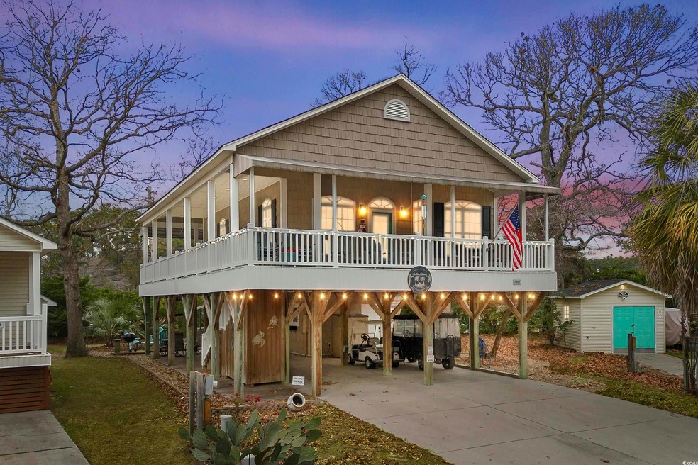 View of front of home with a carport and a storage
