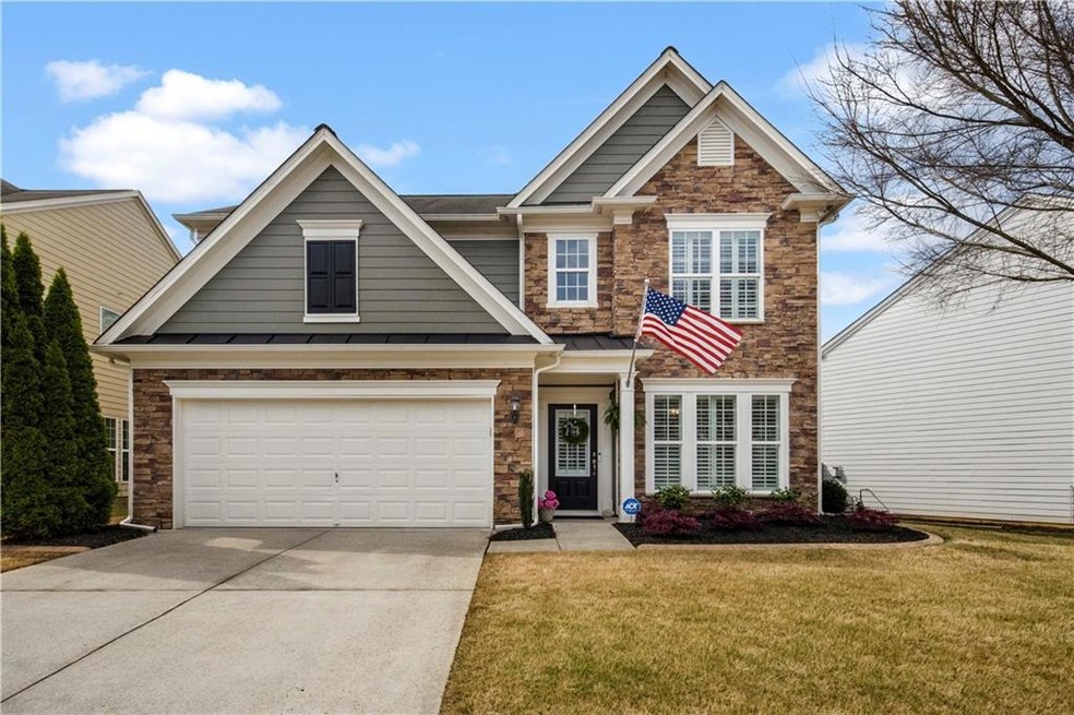 Craftsman-style home with a front yard and a garag