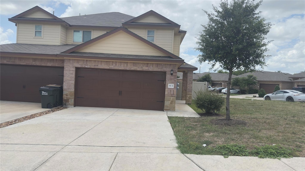 View of front facade with concrete driveway, a sh