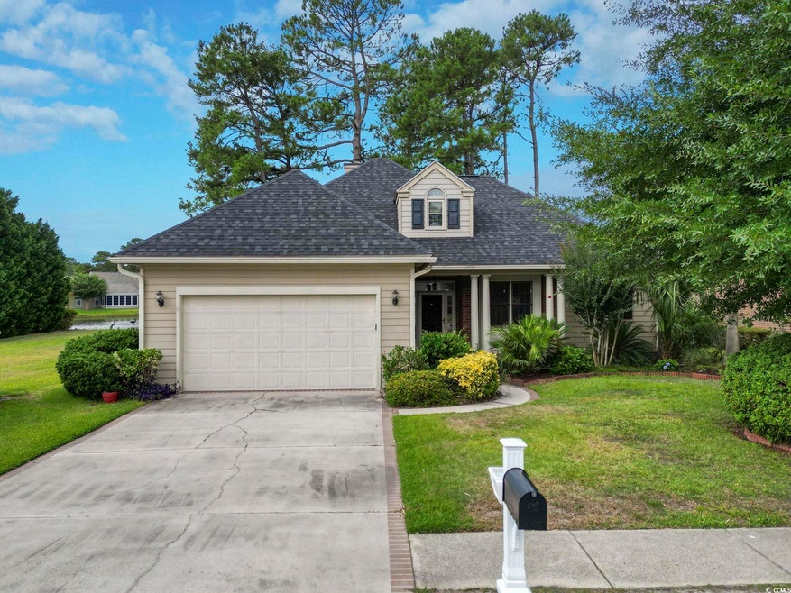 View of front of house with a garage and a front y