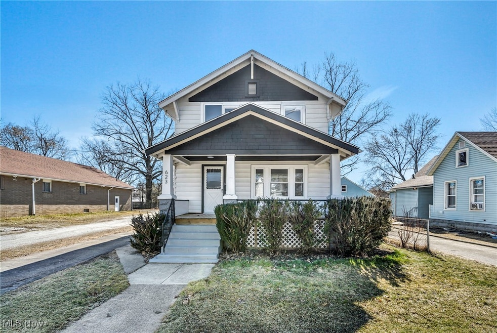 View of front of property with a porch and fence