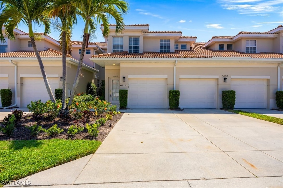 Mediterranean / spanish house featuring concrete driveway, stucco siding, an attached garage, and a tiled roof