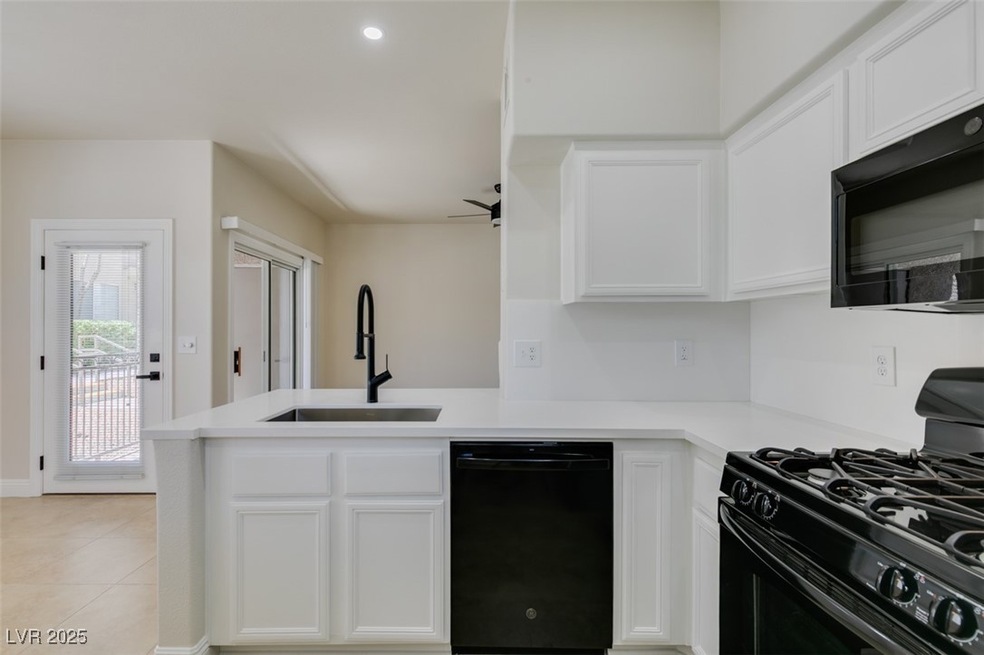 Kitchen featuring black appliances, a sink, a peni