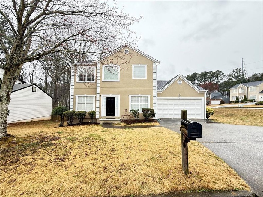 Traditional-style home featuring aphalt driveway, 