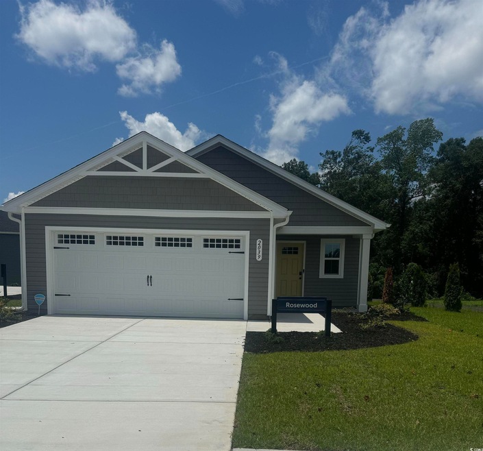 View of front facade with a garage and a front yard